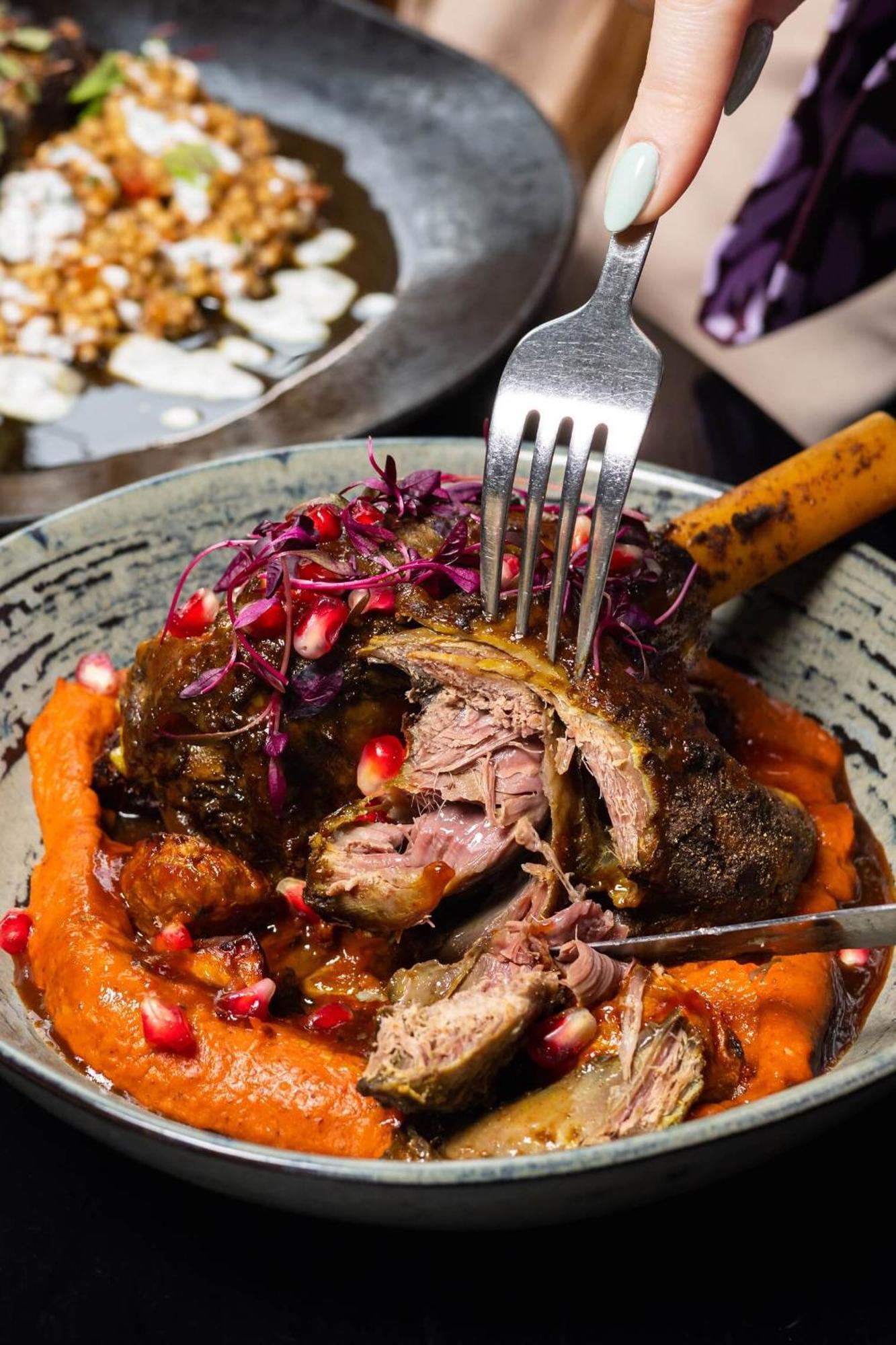 Citysuites Aparthotel Salford  Exterior photo The photo shows a plate of beautifully presented food. At the center, there is a piece of tender meat that appears to be slow-cooked, revealing its juicy interior. The meat is garnished with microgreens and pomegranate seeds, adding vibrant colors an